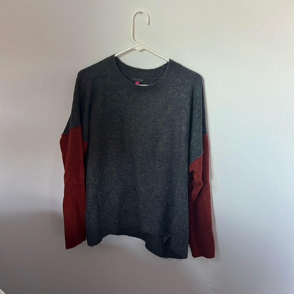 Vince Camuto crew neck sweater with dark gray body and burnt orange sleeves